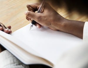 Woman writining in a notebook